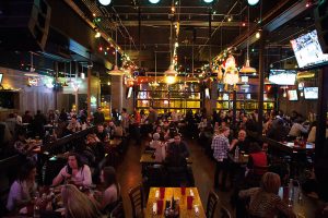 modern bar/dinning area with bustling crowd
